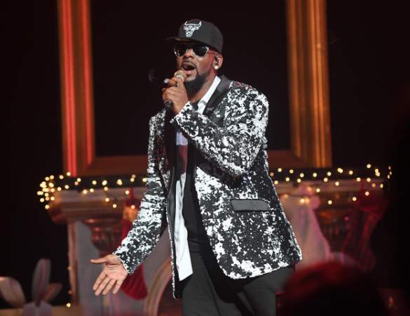 Jaya Kelly, father, R. Kelly, performing on a stage.